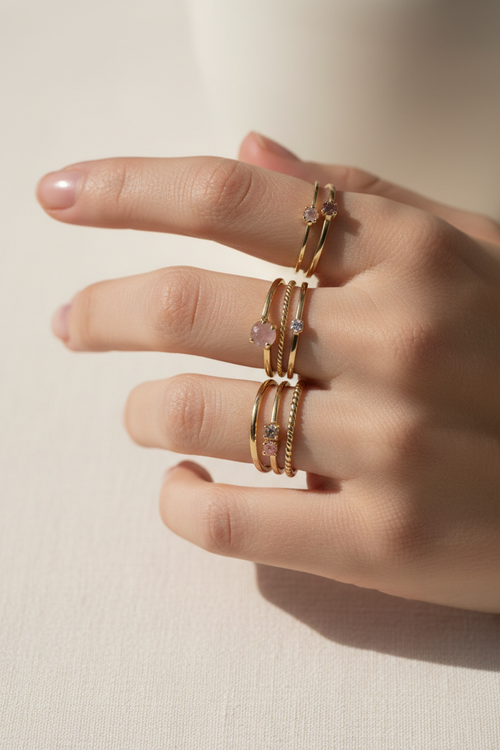 AVYRA Thin Air Stacking Rings — delicate gold bands stacked on feminine fingers